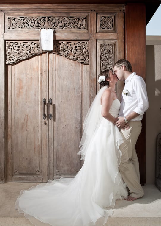 Amanda in her wedding dress at a Balinese doorway